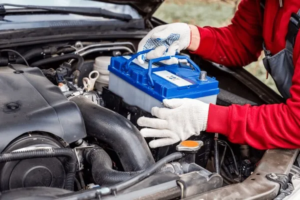 car-mechanic-installs-battery-re